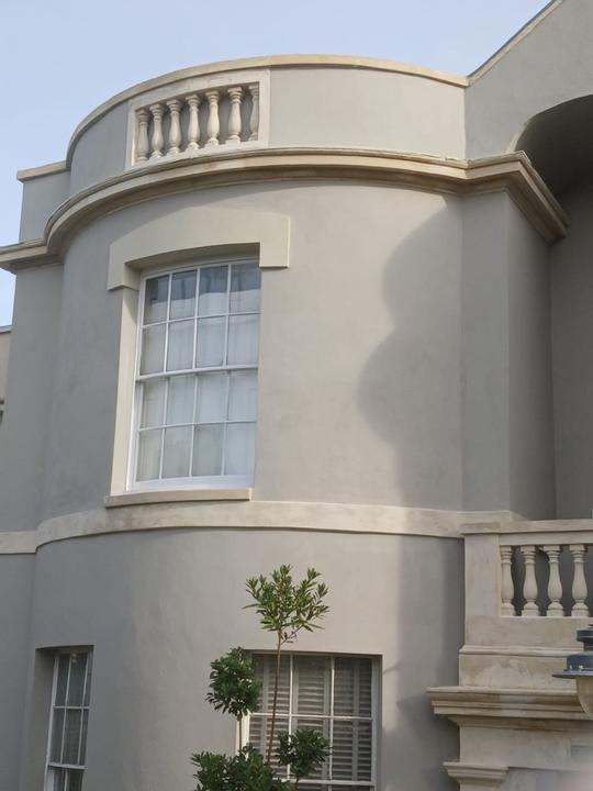 Curved rendered bay with balustrade parapet