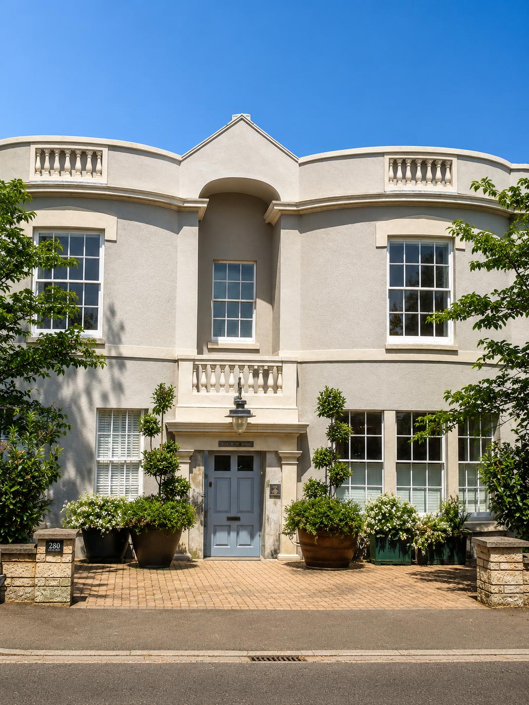 Regency-style frontage with balustrades and stone door surround