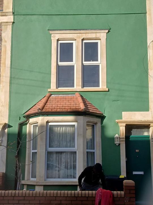 Stone bay window and dressings on a painted terrace