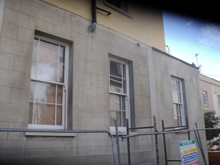 Stone-faced elevation with repaired quoins